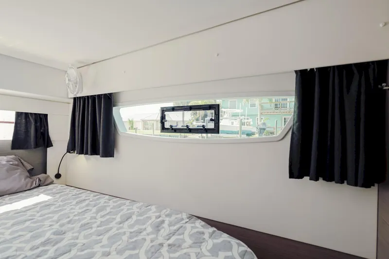 Slide: The Image of Interior cabin of 2020 Fountaine Pajot Saona 47 catamaran with window view and bed. - 50
