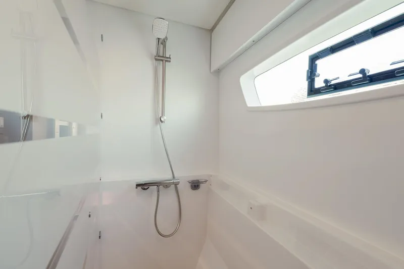 Slide: The Image of Modern shower area in 2020 Fountaine Pajot Saona 47 yacht, featuring sleek design and window. - 57