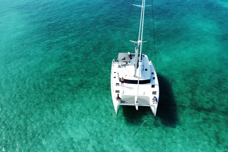 Slide: The Image of Aerial view of 2020 Fountaine Pajot Saona 47 catamaran on clear turquoise water. - 71
