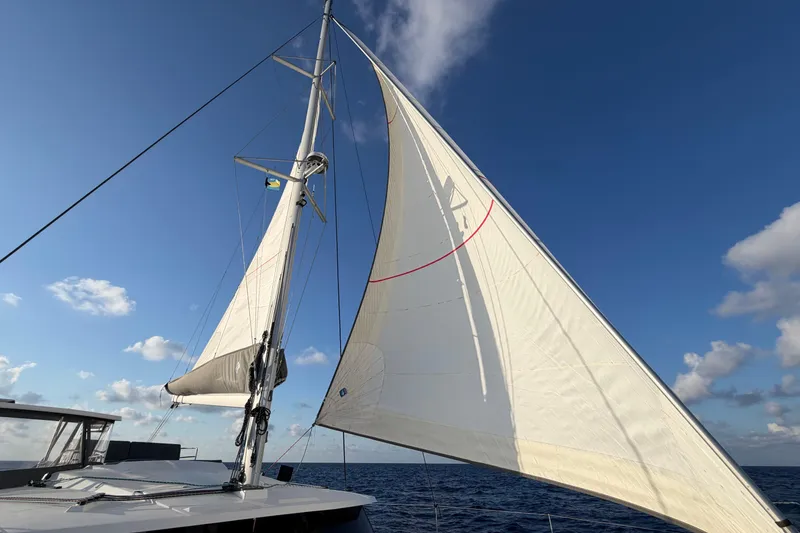 Slide: The Image of Sailing on a 2020 Fountaine Pajot Saona 47 catamaran under clear blue skies. - 73