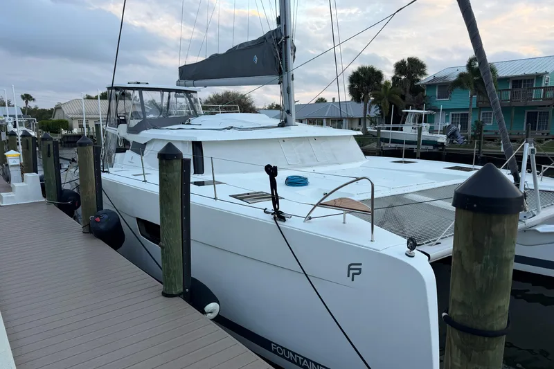 Slide: The Image of 2020 Fountaine Pajot Saona 47 catamaran docked at marina, showcasing sleek design. - 76