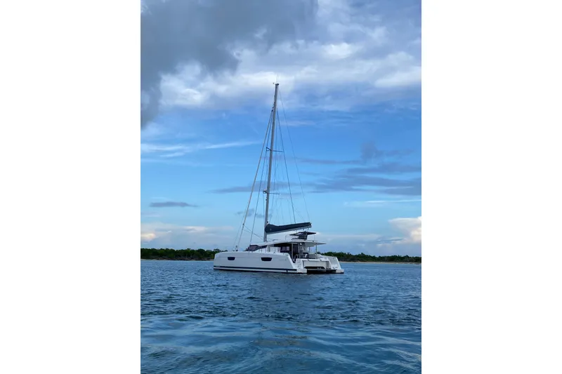 Slide: The Image of 2020 Fountaine Pajot Saona 47 catamaran sailing on calm waters under a cloudy sky. - 78