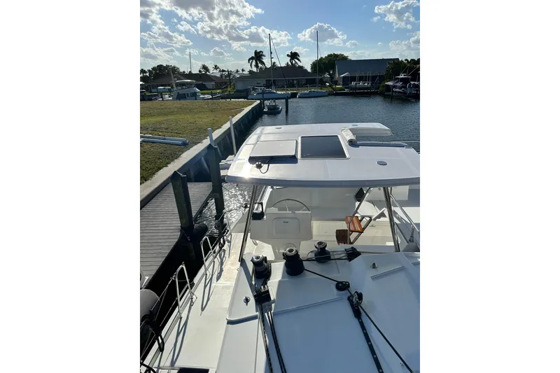 Slide: The Image of 2020 Fountaine Pajot Saona 47 catamaran docked at a marina under a sunny sky. - 80