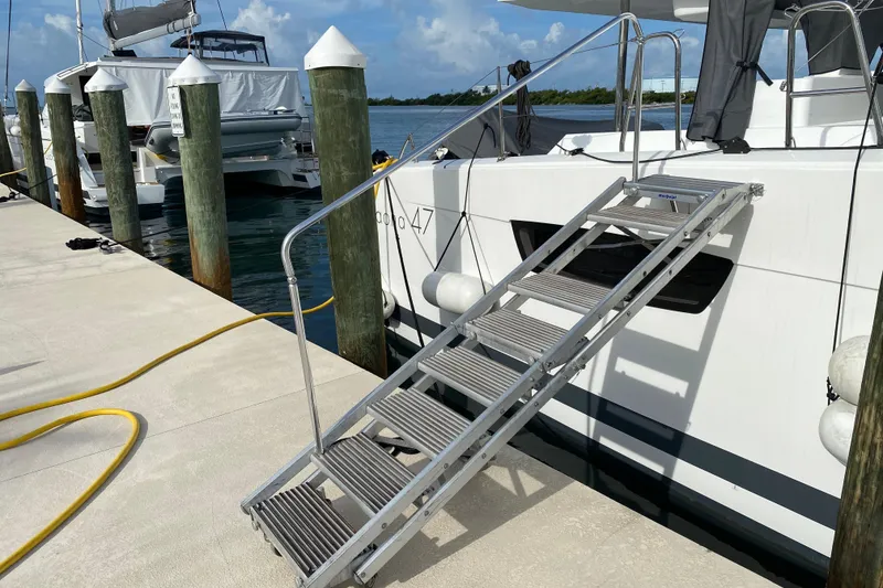 Slide: The Image of Docked 2020 Fountaine Pajot Saona 47 catamaran with boarding ladder and marina view. - 81