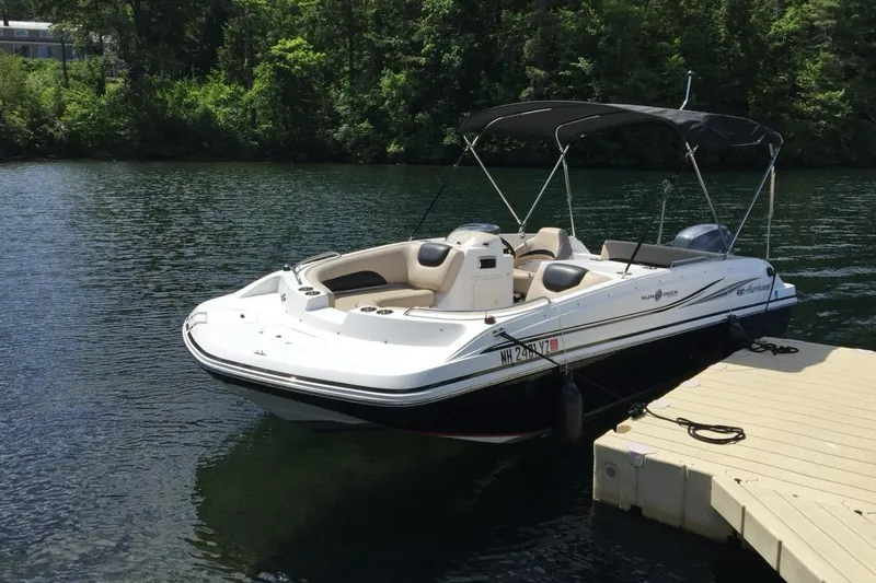 The Image of 2014 Hurricane SunDeck Sport 188 OB boat docked on a serene lake. - 0
