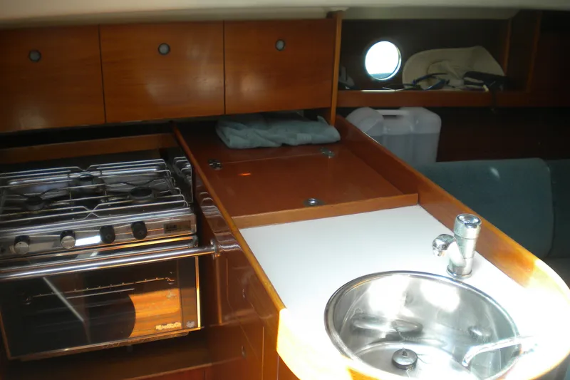 Slide: The Image of Interior of 1994 Beneteau First 310 yacht with kitchen and sink. - 15