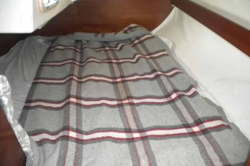 Slide: The Image of Cozy cabin bed with plaid blanket in 1994 Beneteau First 310 sailboat. - 16