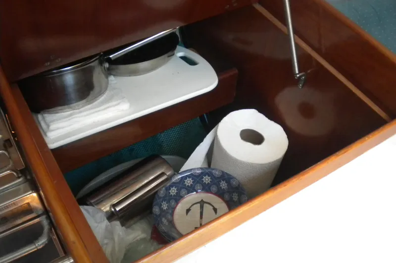 Slide: The Image of Storage compartment in 1994 Beneteau First 310 yacht with kitchen essentials. - 18