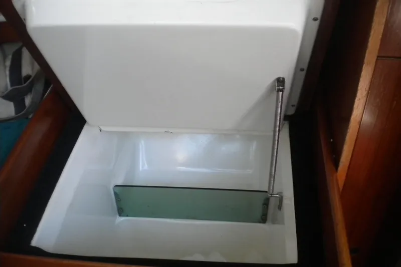 Slide: The Image of Interior storage compartment of a 1994 Beneteau First 310 sailboat, featuring a hinged lid. - 20
