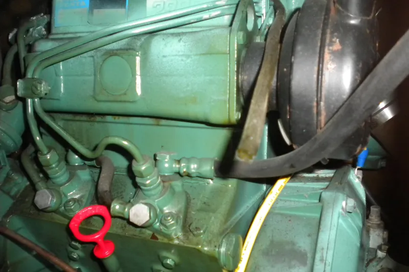 Slide: The Image of Close-up of a 1994 Beneteau First 310 engine, showcasing mechanical components and details. - 24