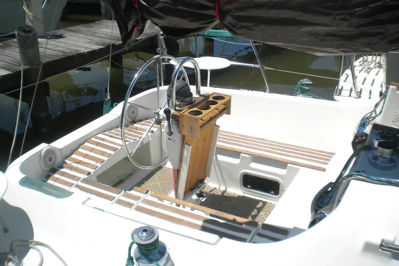 Slide: The Image of Cockpit of 1994 Beneteau First 310 sailboat with steering wheel and wooden accents. - 5