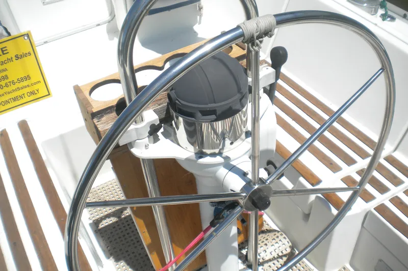 Slide: The Image of Steering wheel of a 1994 Beneteau First 310 sailboat with wooden seating. - 6