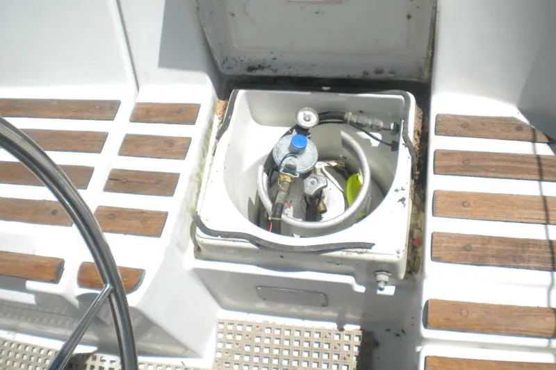 Slide: The Image of Cockpit view of a 1994 Beneteau First 310 sailboat with gas cylinder compartment. - 8