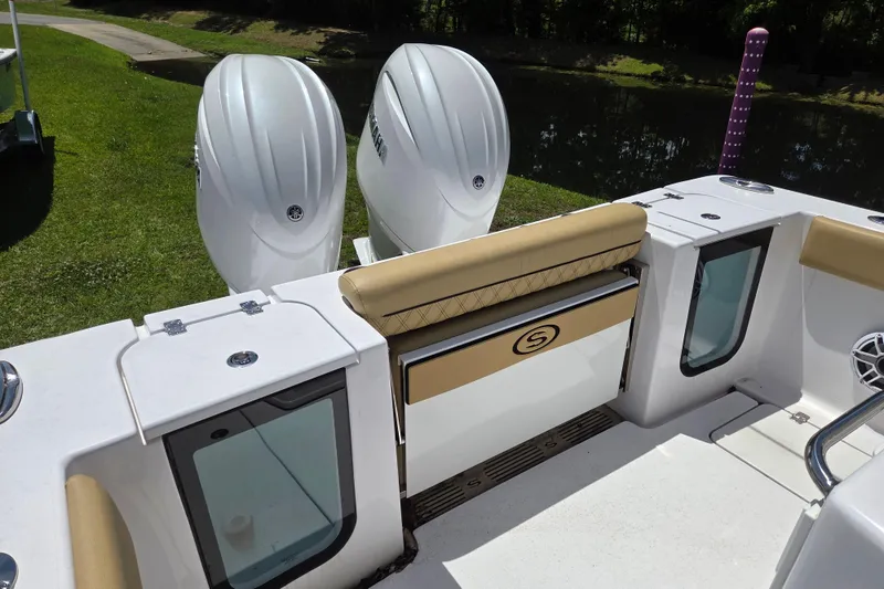 Slide: The Image of 2025 Sportsman Open 262 Center Console boat with dual engines and cushioned seating. - 10