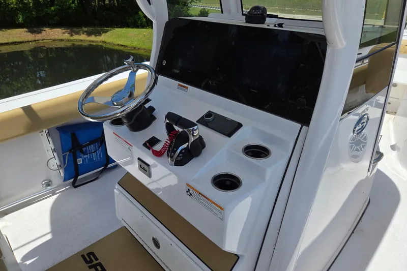 Slide: The Image of 2025 Sportsman Open 262 Center Console boat dashboard with steering wheel and controls. - 12