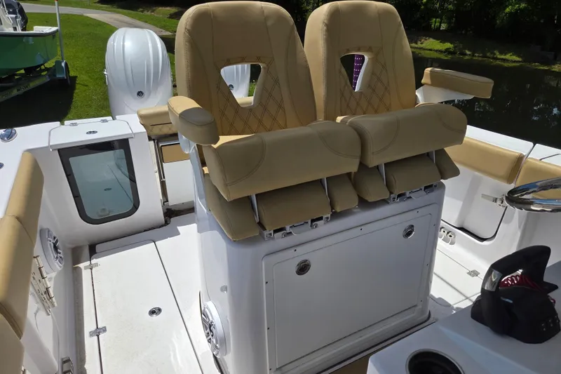 Slide: The Image of 2025 Sportsman Open 262 Center Console boat with tan seating and modern design. - 13