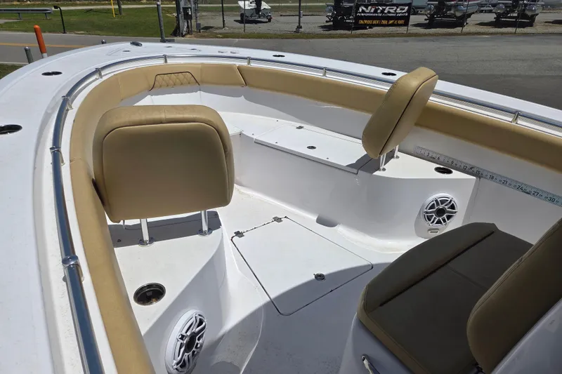 Slide: The Image of 2025 Sportsman Open 262 Center Console boat interior with tan seating and speakers. - 16
