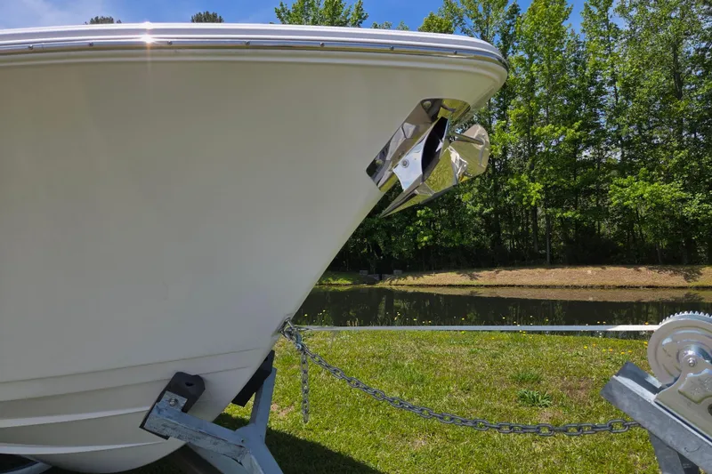 Slide: The Image of 2025 Sportsman Open 262 Center Console boat on trailer by a pond. - 8
