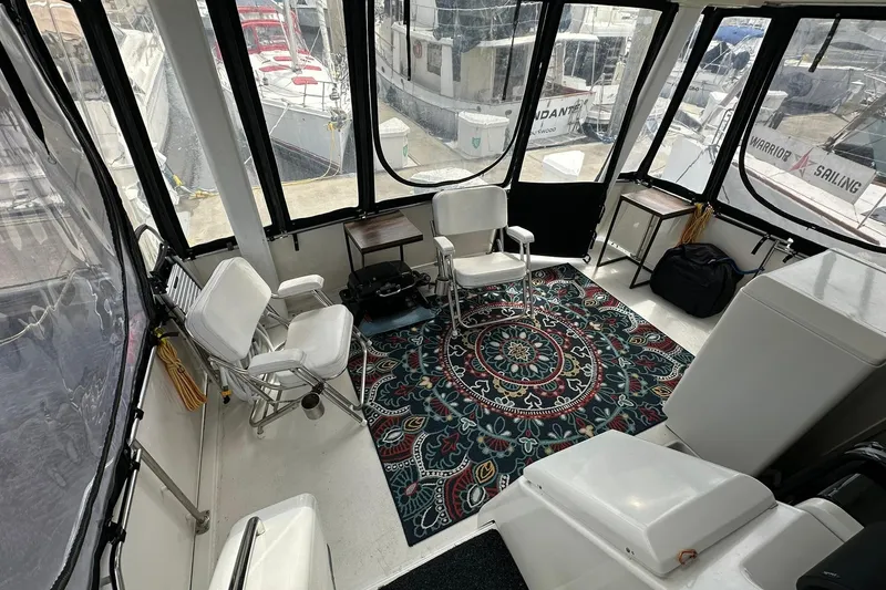 Slide: The Image of 1997 Carver 355 Aft Cabin Motor Yacht interior with chairs and decorative rug. - 21