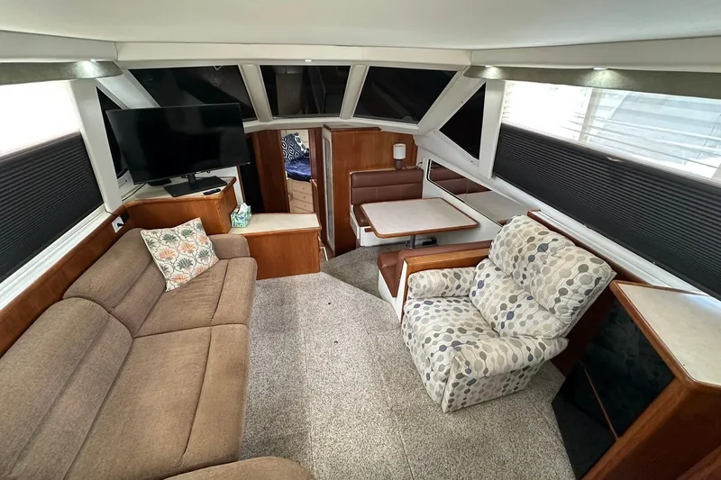 Slide: The Image of Interior of 1997 Carver 355 Aft Cabin Motor Yacht with cozy seating and modern amenities. - 22