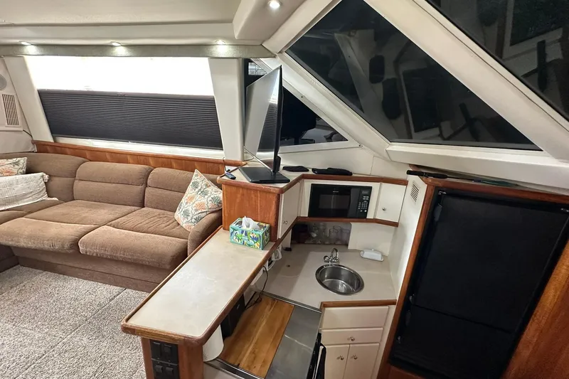 Slide: The Image of Interior of 1997 Carver 355 Aft Cabin Motor Yacht with cozy seating and compact kitchen. - 25