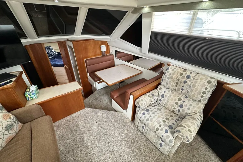 Slide: The Image of Interior of 1997 Carver 355 Aft Cabin Motor Yacht with cozy seating and dining area. - 26