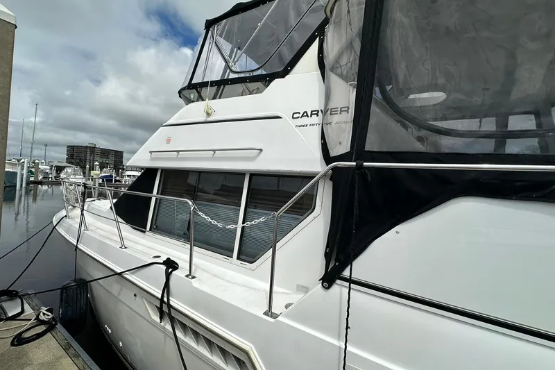 Slide: The Image of 1997 Carver 355 Aft Cabin Motor Yacht docked at marina under cloudy skies. - 3