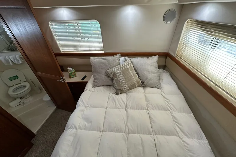 Slide: The Image of Cozy bedroom in 1997 Carver 355 Aft Cabin Motor Yacht with adjacent bathroom. - 30