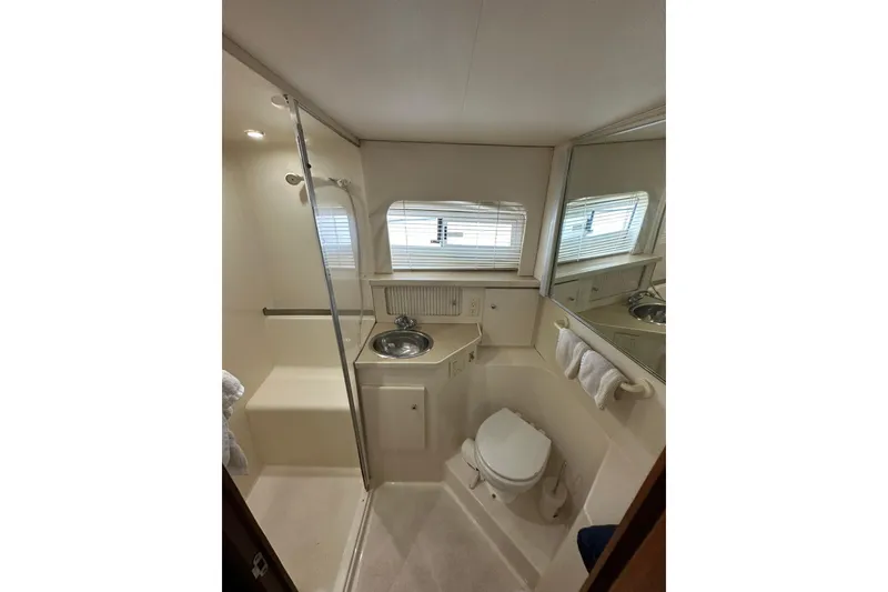 Slide: The Image of Bathroom interior of 1997 Carver 355 Aft Cabin Motor Yacht, featuring shower and sink. - 32