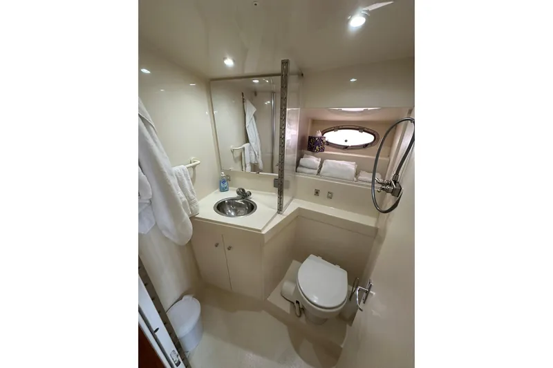 Slide: The Image of Bathroom interior of 1997 Carver 355 Aft Cabin Motor Yacht, featuring sink and toilet. - 35