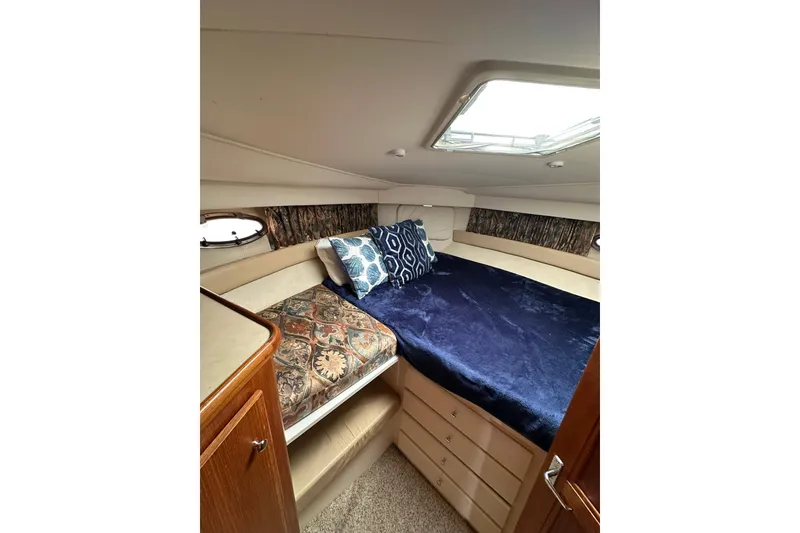 Slide: The Image of 1997 Carver 355 Aft Cabin Motor Yacht interior cabin with bed and decorative pillows. - 36