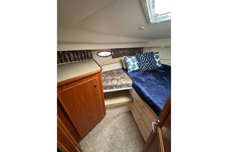 Slide: The Image of Cozy cabin interior of 1997 Carver 355 Aft Cabin Motor Yacht with plush bedding. - 37