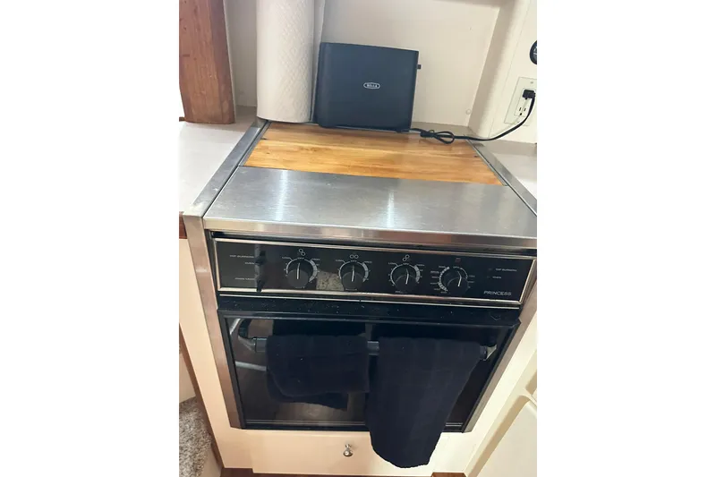 Slide: The Image of 1997 Carver 355 Aft Cabin Motor Yacht kitchen with stainless steel oven and wooden countertop. - 39