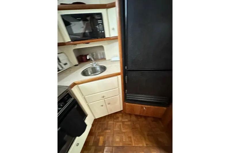 Slide: The Image of Interior of 1997 Carver 355 Aft Cabin Motor Yacht kitchen with sink and appliances. - 40