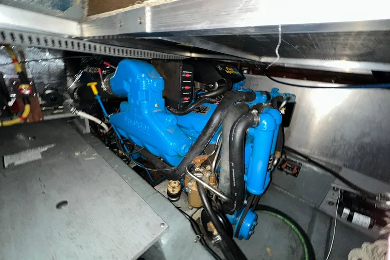 Slide: The Image of Engine compartment of a 1997 Carver 355 Aft Cabin Motor Yacht, featuring a blue engine. - 43