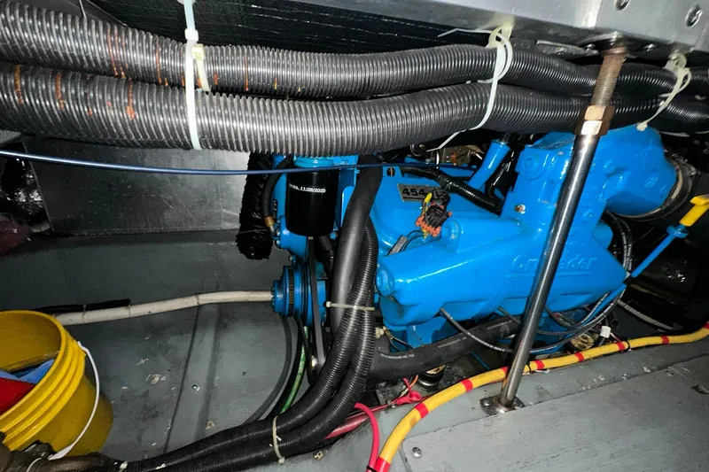Slide: The Image of Engine room of 1997 Carver 355 Aft Cabin Motor Yacht with blue engine components. - 44