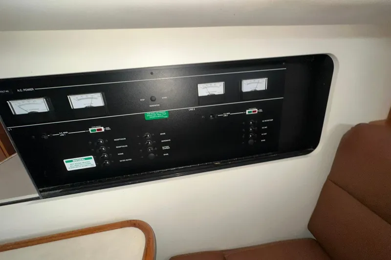 Slide: The Image of Control panel inside 1997 Carver 355 Aft Cabin Motor Yacht, featuring gauges and switches. - 46