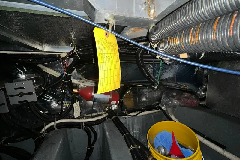 Slide: The Image of Engine room of 1997 Carver 355 Aft Cabin Motor Yacht with wiring and maintenance tools. - 48