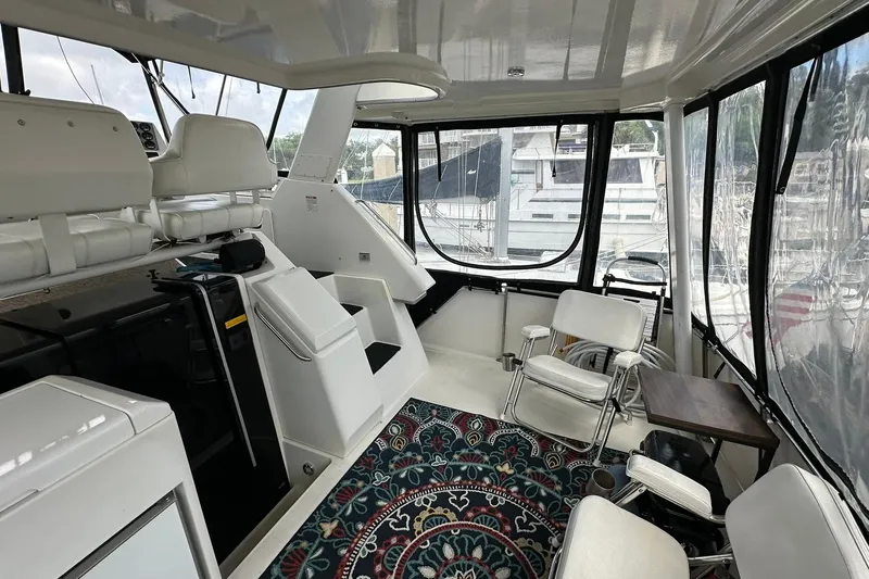 Slide: The Image of 1997 Carver 355 Aft Cabin Motor Yacht interior with seating and nautical decor. - 7
