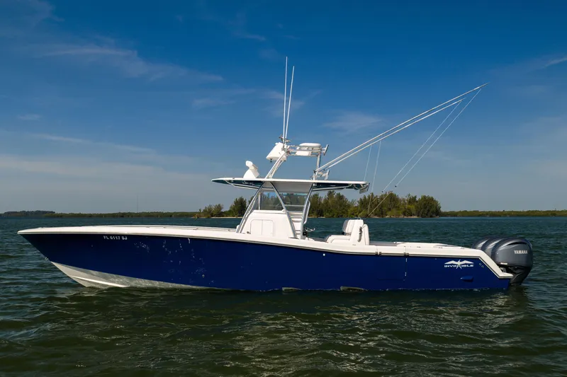 The Image of 2015 Invincible 39 Open Fisherman boat on calm water under clear blue sky. - 1