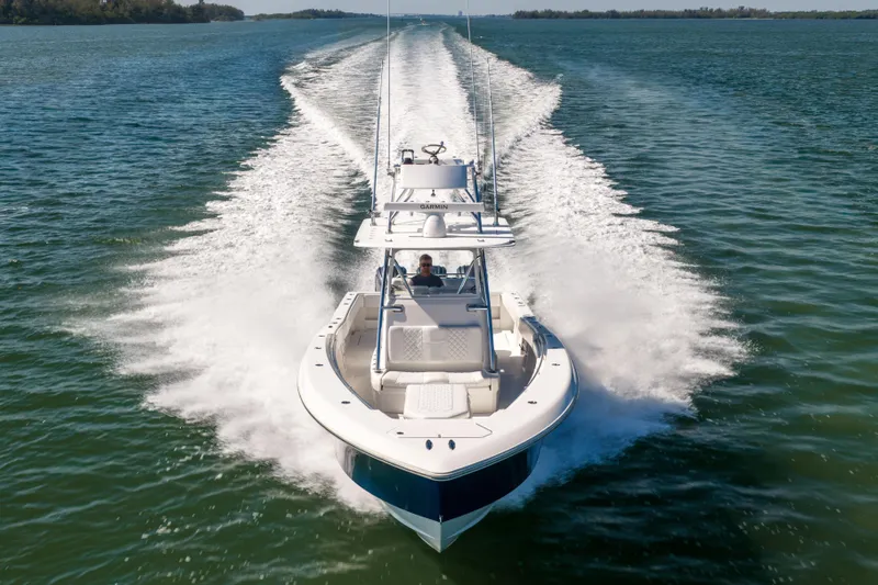 Slide: The Image of 2015 Invincible 39 Open Fisherman speeding on open water, creating a dynamic wake. - 10