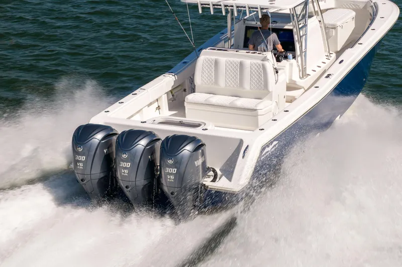Slide: The Image of 2015 Invincible 39 Open Fisherman boat with triple Yamaha 300 engines on water. - 11