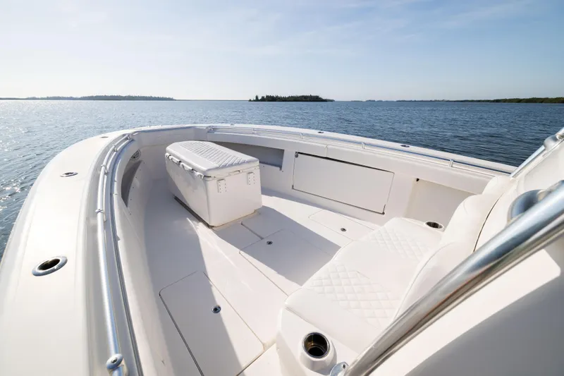 Slide: The Image of 2015 Invincible 39 Open Fisherman boat on calm water, featuring spacious deck and seating. - 13