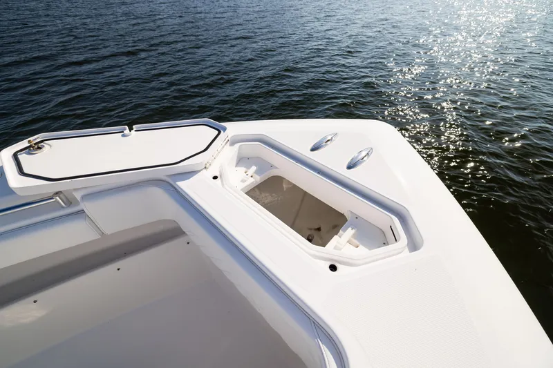 Slide: The Image of 2015 Invincible 39 Open Fisherman boat deck with storage compartment, on calm water. - 21