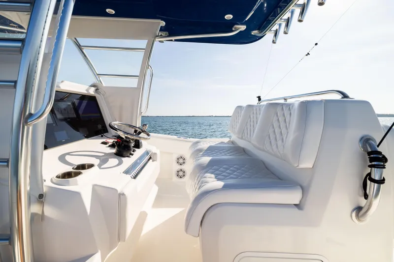 Slide: The Image of 2015 Invincible 39 Open Fisherman boat interior with white seating and steering console. - 26