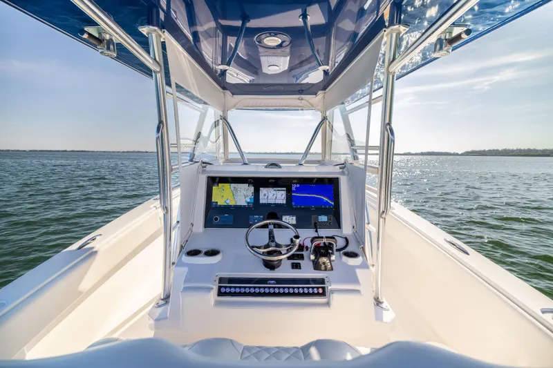 Slide: The Image of 2015 Invincible 39 Open Fisherman boat dashboard with navigation screens on open water. - 29