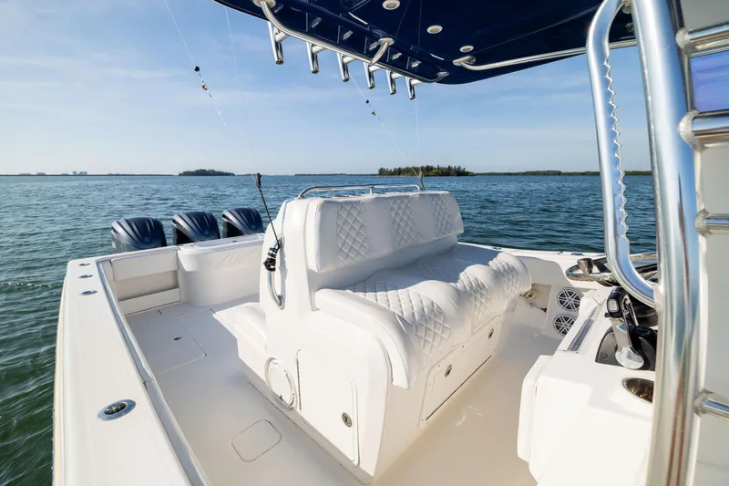 Slide: The Image of 2015 Invincible 39 Open Fisherman boat with triple engines on calm water. - 31
