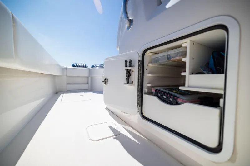 Slide: The Image of Storage compartment on 2015 Invincible 39 Open Fisherman boat, showcasing organized fishing gear. - 32