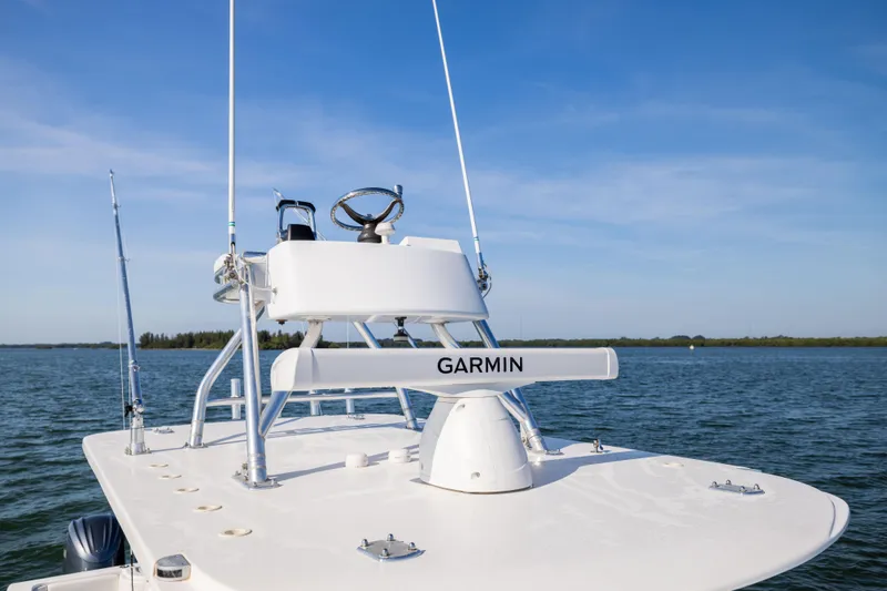 Slide: The Image of 2015 Invincible 39 Open Fisherman boat with Garmin equipment on calm waters. - 33