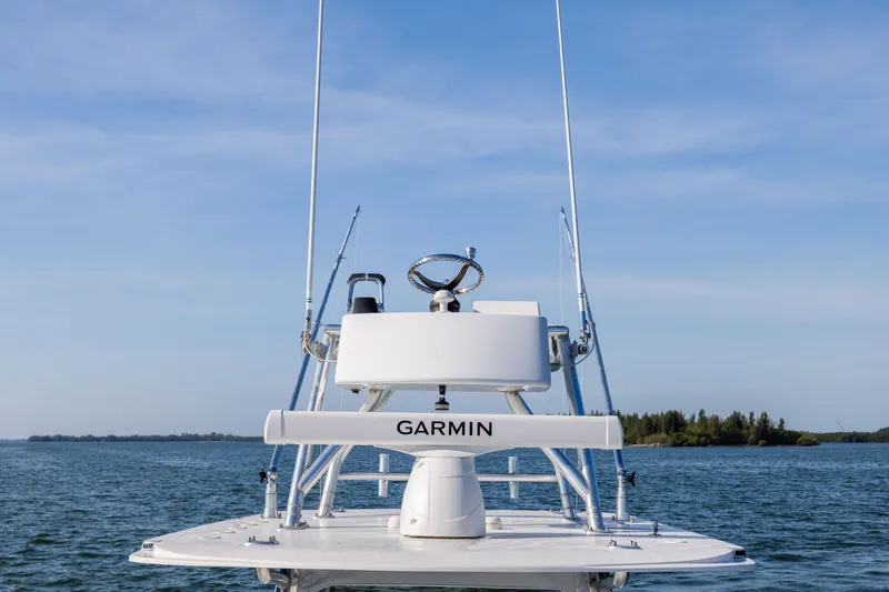 Slide: The Image of 2015 Invincible 39 Open Fisherman boat with Garmin equipment on calm water. - 34